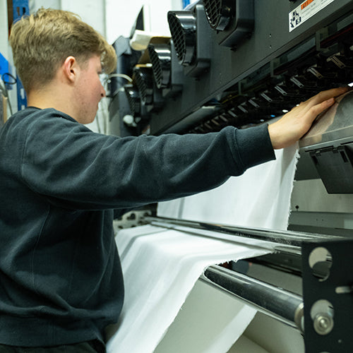 Sewing handmade fabric products in UK workshop