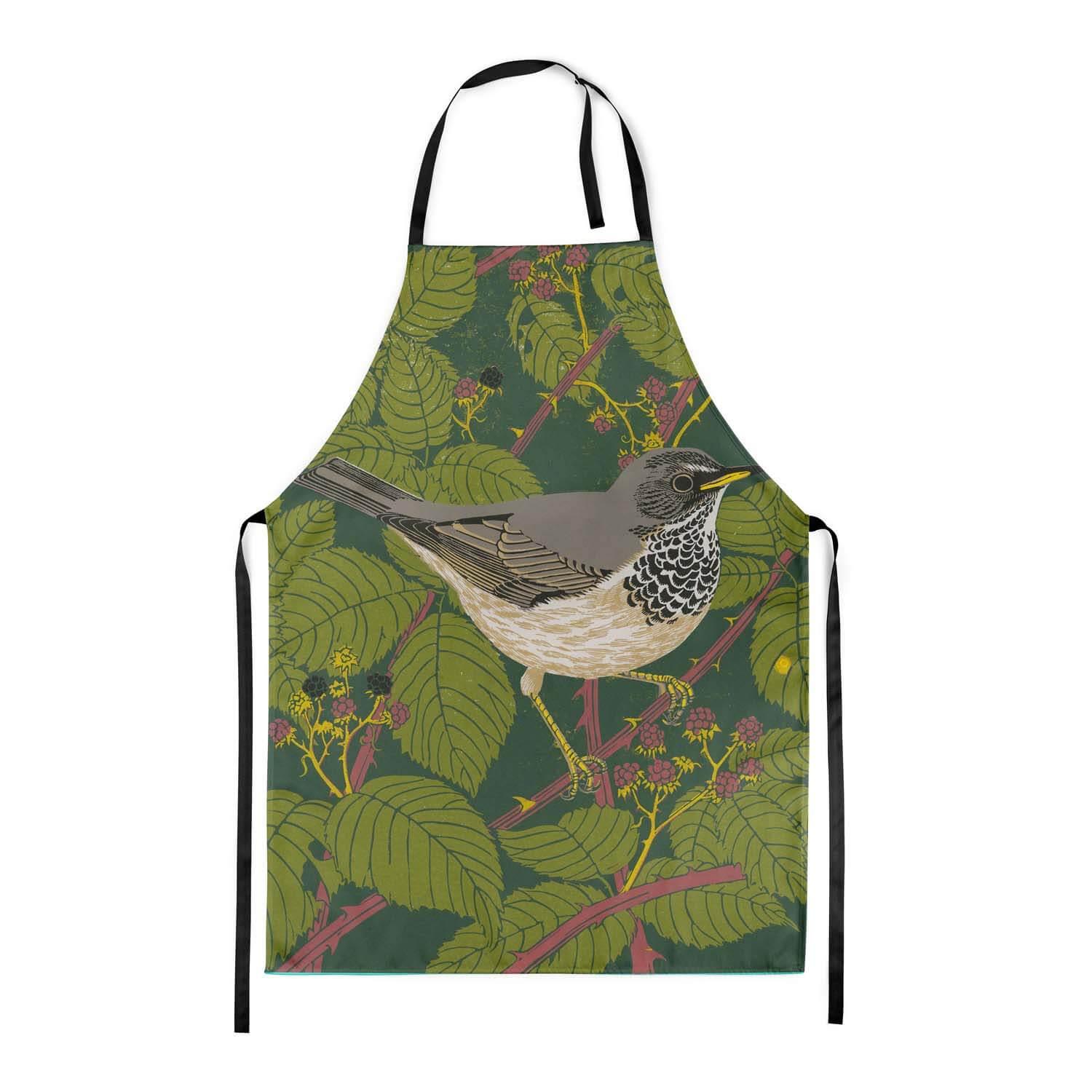 A green apron with black straps,  a grey and white thrush is on the front.